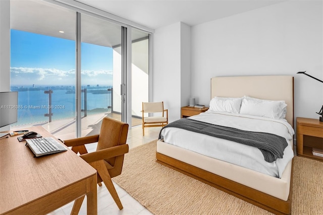 bedroom featuring access to exterior, floor to ceiling windows, a water view, and light tile patterned flooring