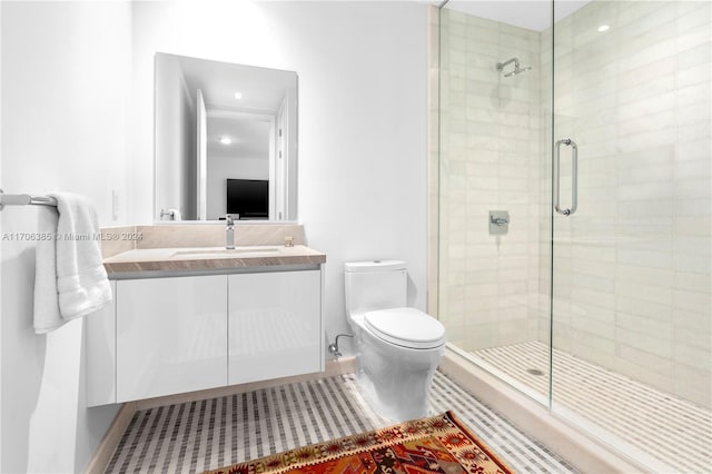 bathroom featuring vanity, toilet, and an enclosed shower