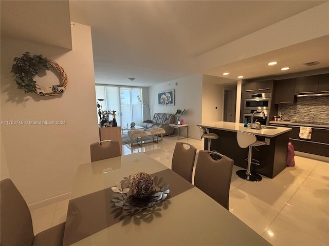 dining space with sink and light tile patterned flooring