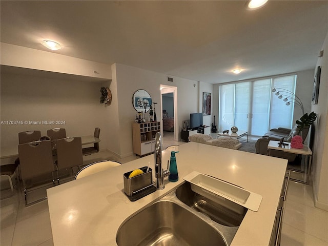 kitchen featuring sink, a center island, and light tile patterned floors