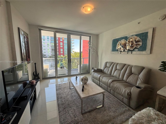 living room with floor to ceiling windows and light tile patterned floors