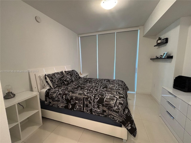 tiled bedroom with a closet