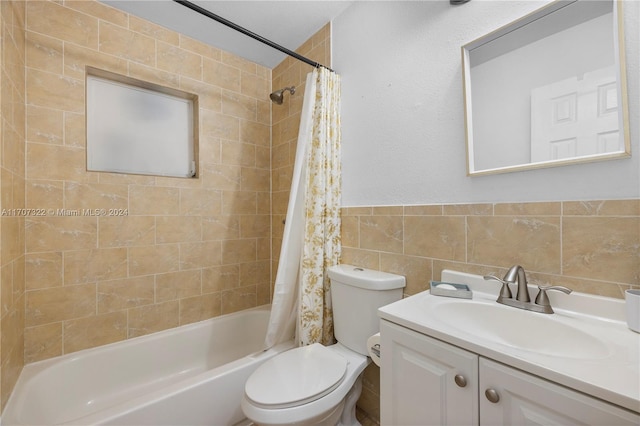 full bathroom featuring vanity, toilet, tile walls, and shower / tub combo