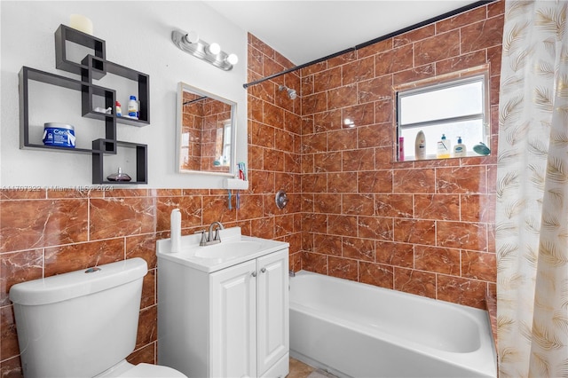 full bathroom featuring shower / tub combo, vanity, tile walls, and toilet