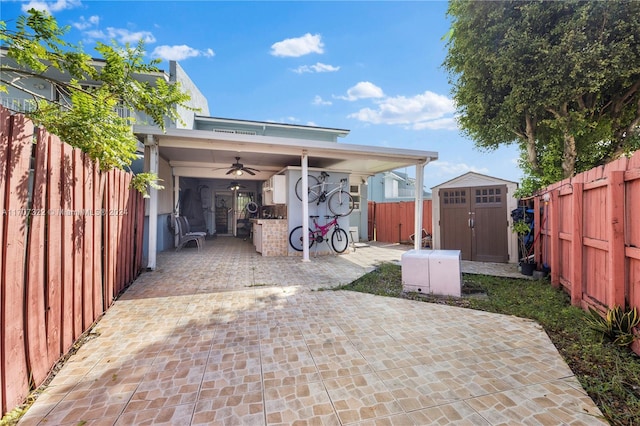 exterior space with ceiling fan and a storage unit