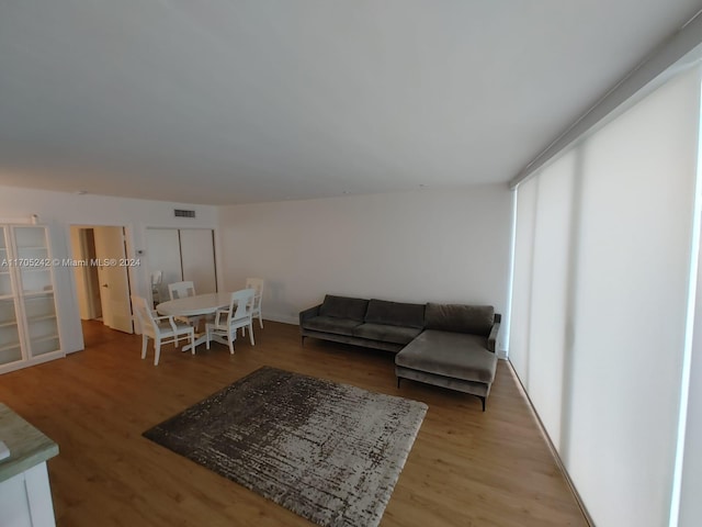 10210 Collins Ave Unit 306, Bal Harbour, FL 33154 - living room with light wood-style flooring and healthy amount of natural light