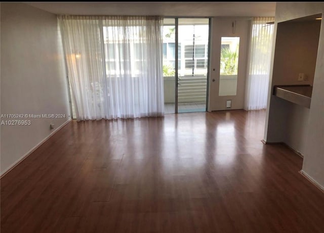 10210 Collins Ave Unit 306, Bal Harbour, FL 33154 - unfurnished room featuring wood finished floors and baseboards