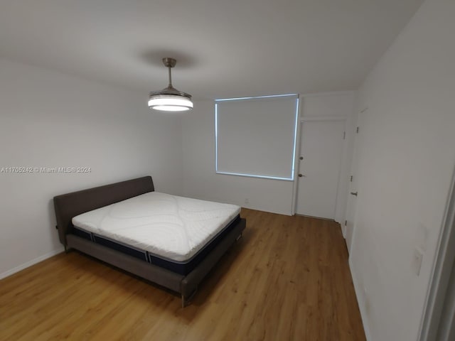 bedroom with hardwood / wood-style floors