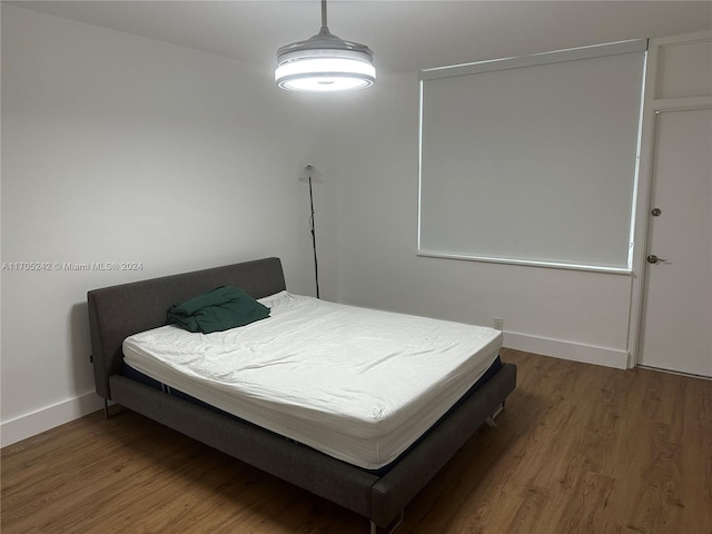 bedroom with hardwood / wood-style floors