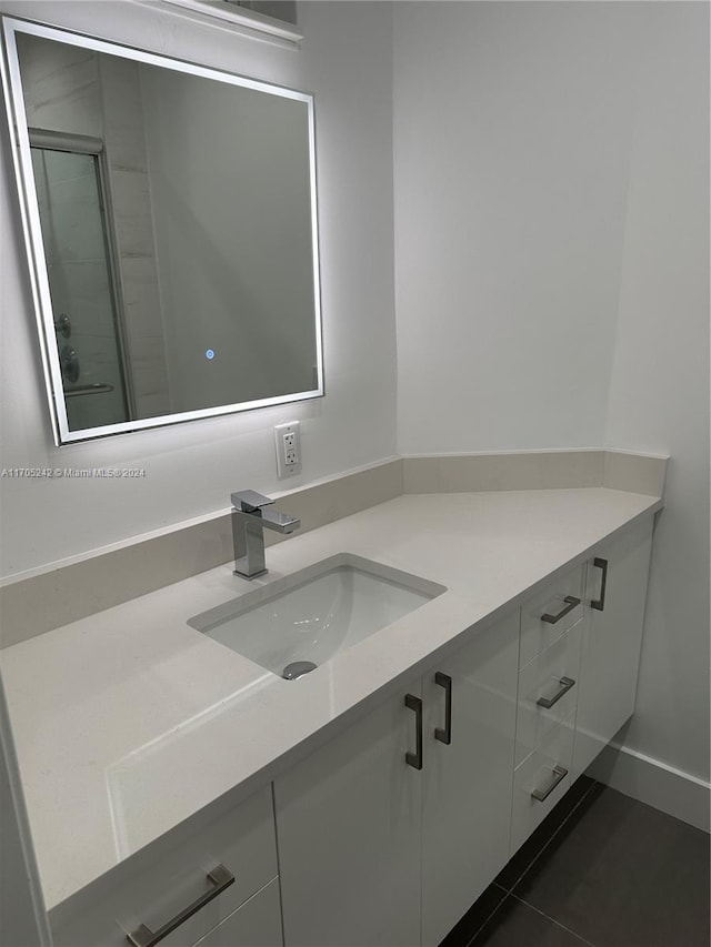 10210 Collins Ave Unit 306, Bal Harbour, FL 33154 - bathroom featuring vanity, tile patterned floors, and a stall shower