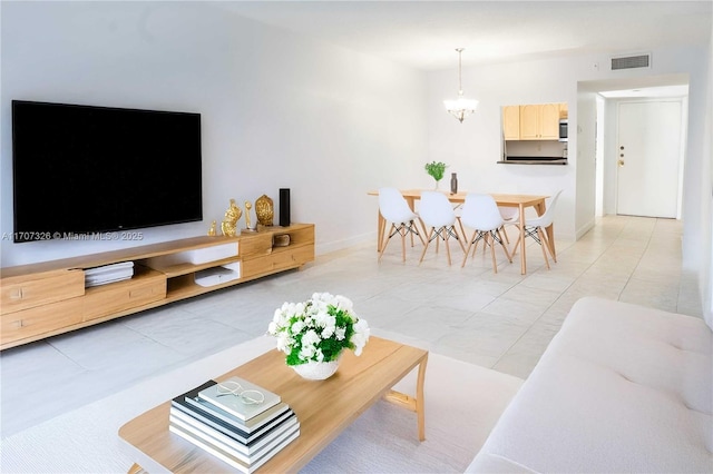 tiled living room featuring a notable chandelier