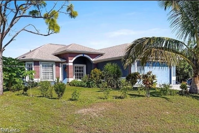 ranch-style home featuring a front yard and a garage