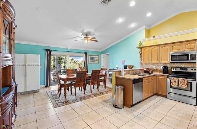 kitchen featuring ceiling fan, kitchen peninsula, appliances with stainless steel finishes, light tile patterned floors, and ornamental molding