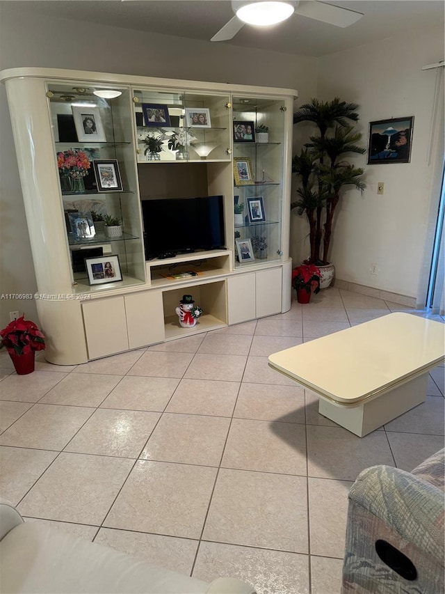 living room featuring ceiling fan and light tile patterned floors