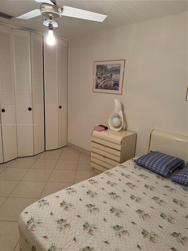 tiled bedroom with a closet and ceiling fan