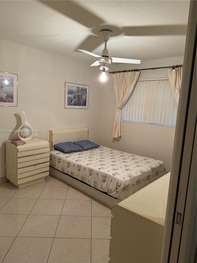 tiled bedroom featuring ceiling fan