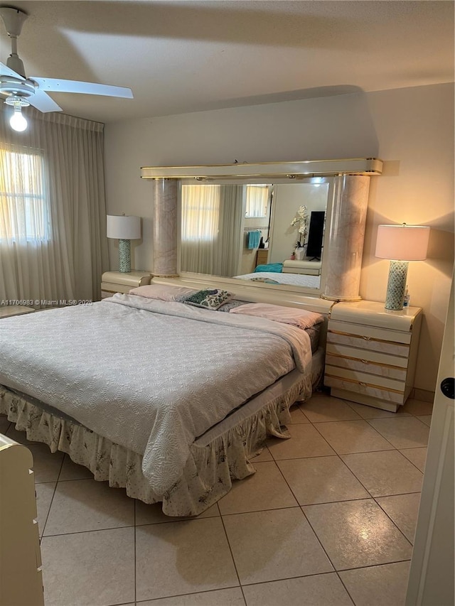 tiled bedroom featuring ceiling fan