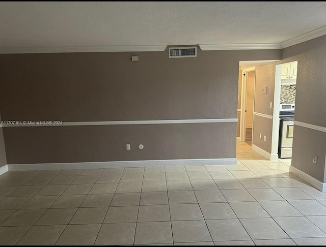 tiled empty room featuring ornamental molding