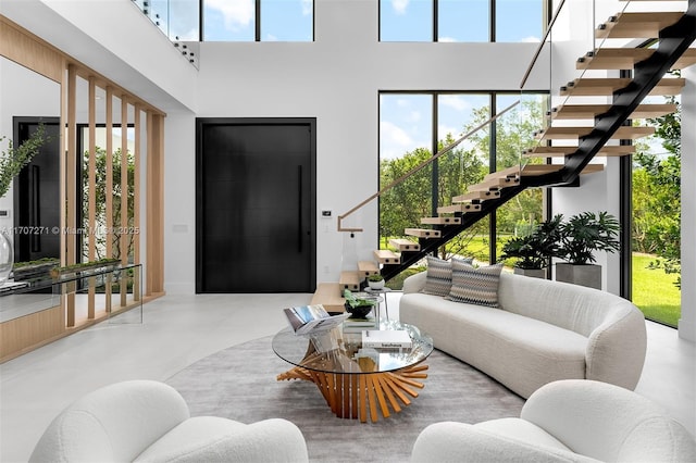 living room featuring plenty of natural light and a high ceiling