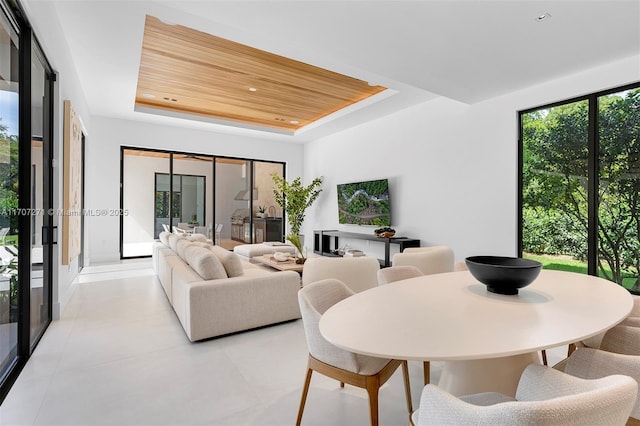 living room featuring a raised ceiling and wooden ceiling