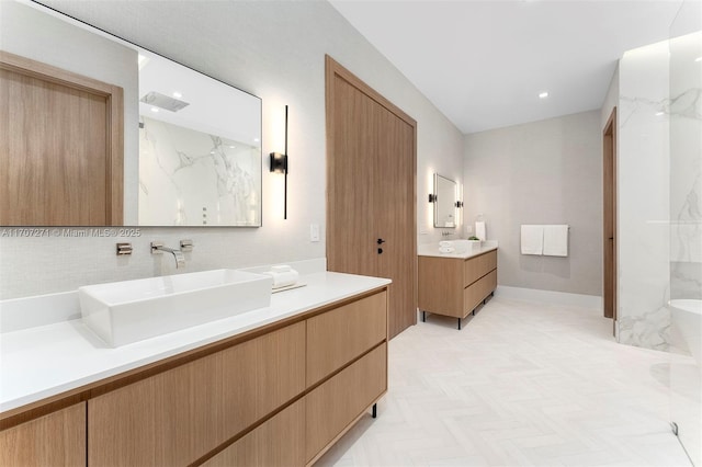 bathroom featuring parquet flooring, decorative backsplash, and vanity