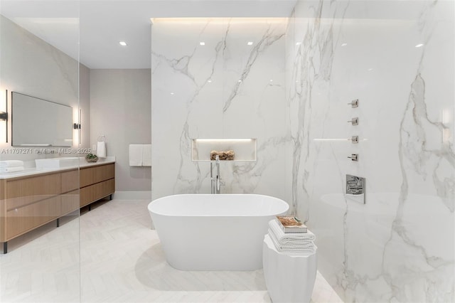 bathroom with a washtub and vanity