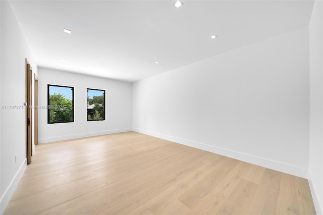 spare room with light hardwood / wood-style flooring