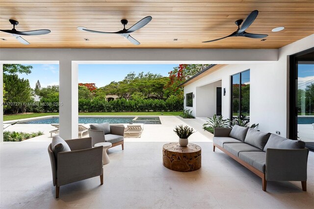 view of patio / terrace with ceiling fan and an outdoor living space