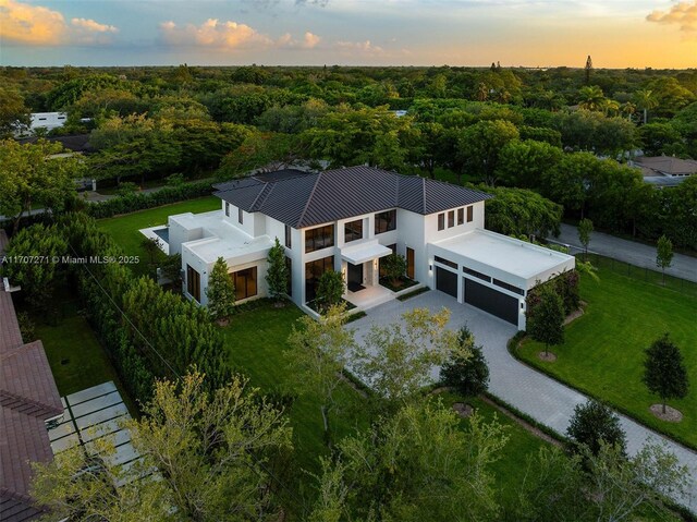 pool at dusk with a lawn, an outdoor living space, and a patio