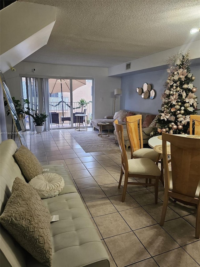 living room with tile patterned flooring and a textured ceiling