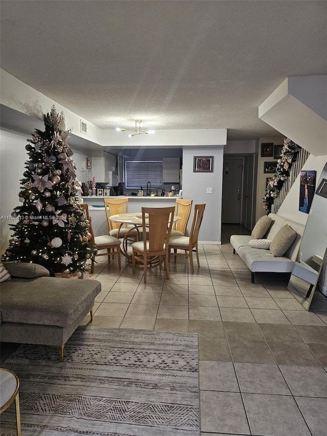 tiled dining area featuring a textured ceiling