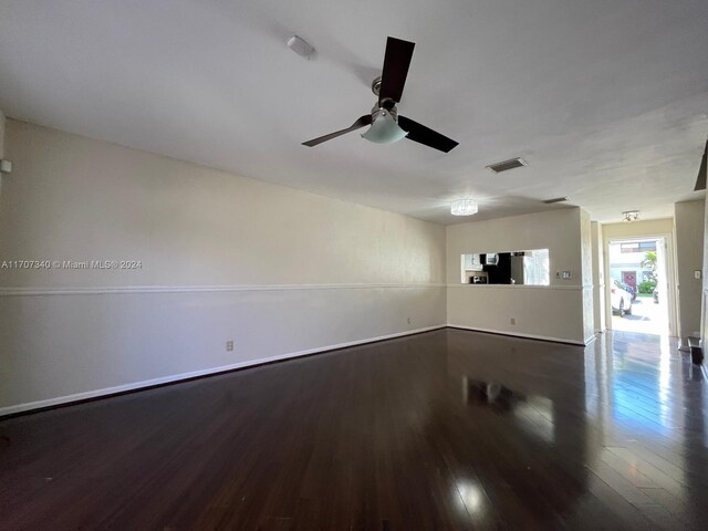 empty room with hardwood / wood-style flooring and ceiling fan