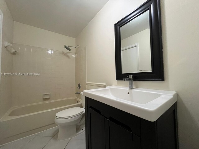 full bathroom featuring tile patterned flooring, vanity, toilet, and tiled shower / bath combo