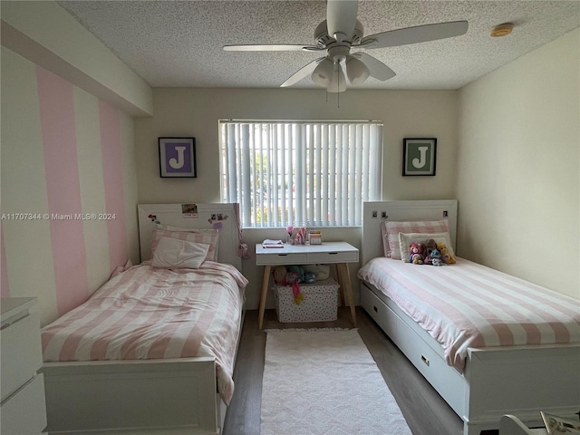 bedroom featuring wood-type flooring, a textured ceiling, and ceiling fan