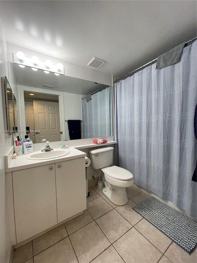 bathroom featuring tile patterned flooring, vanity, toilet, and a shower with shower curtain