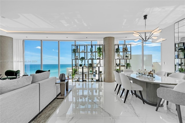 dining space with a notable chandelier, expansive windows, and a water view