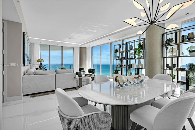 dining room with floor to ceiling windows and a water view