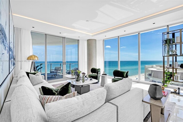 living room with floor to ceiling windows and a water view