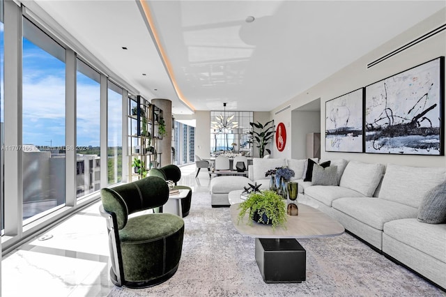 living room featuring a chandelier and a wall of windows