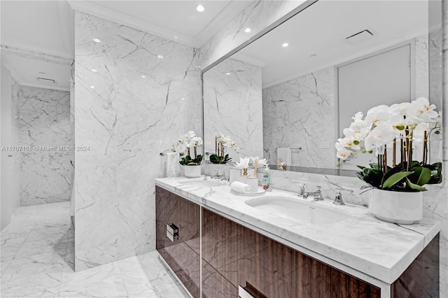 bathroom with vanity, crown molding, and tile walls