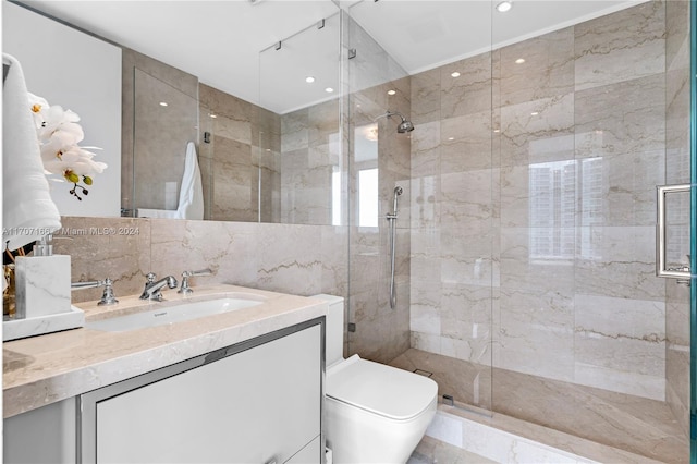 bathroom with vanity, toilet, a shower with door, and tile walls