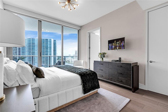 bedroom featuring light hardwood / wood-style flooring and a notable chandelier