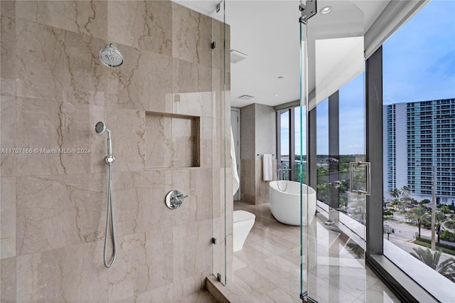 bathroom featuring separate shower and tub and expansive windows