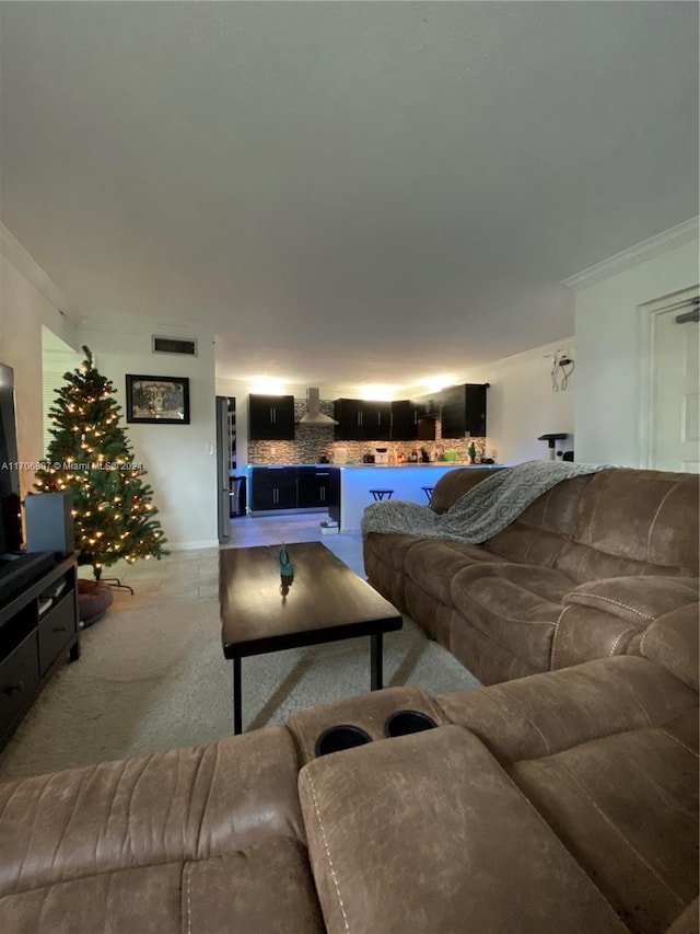 carpeted living room with crown molding