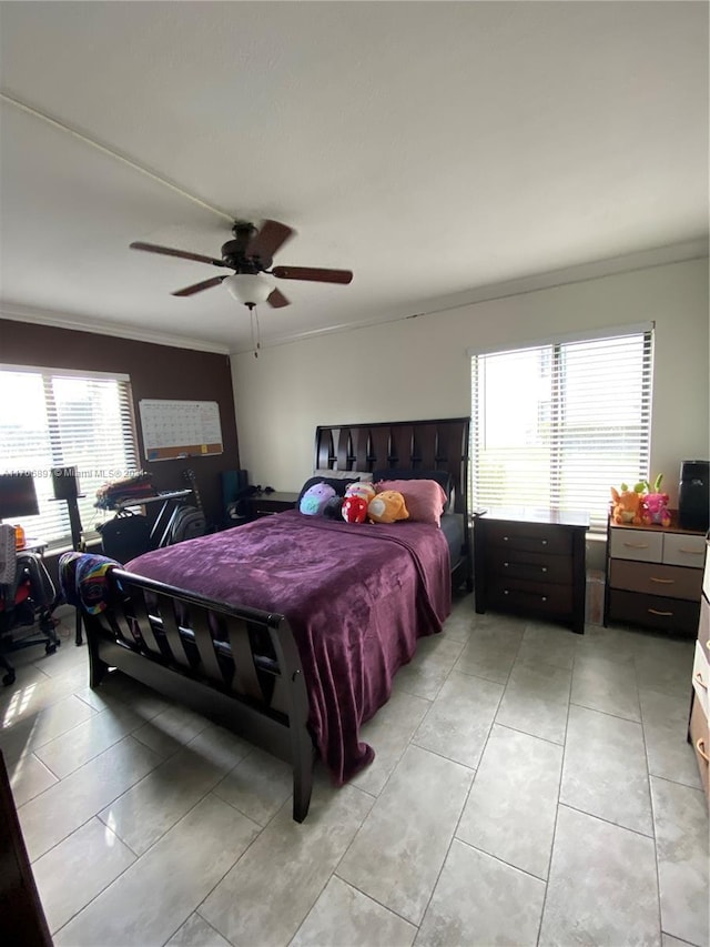 bedroom with ceiling fan, crown molding, and multiple windows