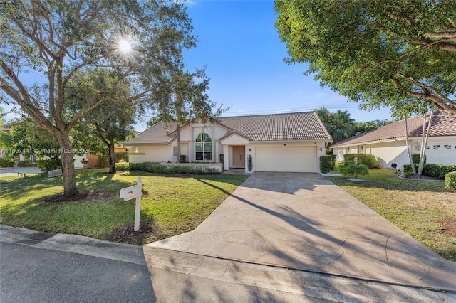 view of front of home featuring a front yard and a garage