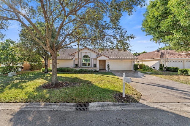 view of front of house with a front lawn and a garage