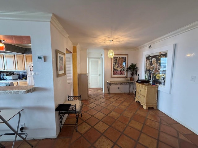 kitchen featuring pendant lighting, a notable chandelier, white refrigerator, and crown molding