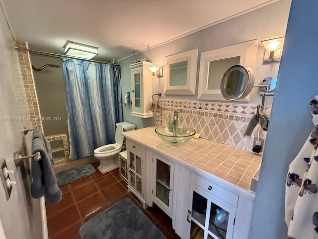 bathroom with decorative backsplash, vanity, toilet, and walk in shower