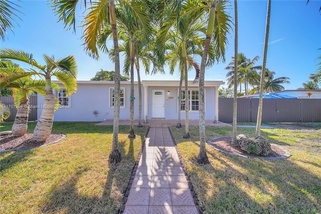 ranch-style home with a front yard